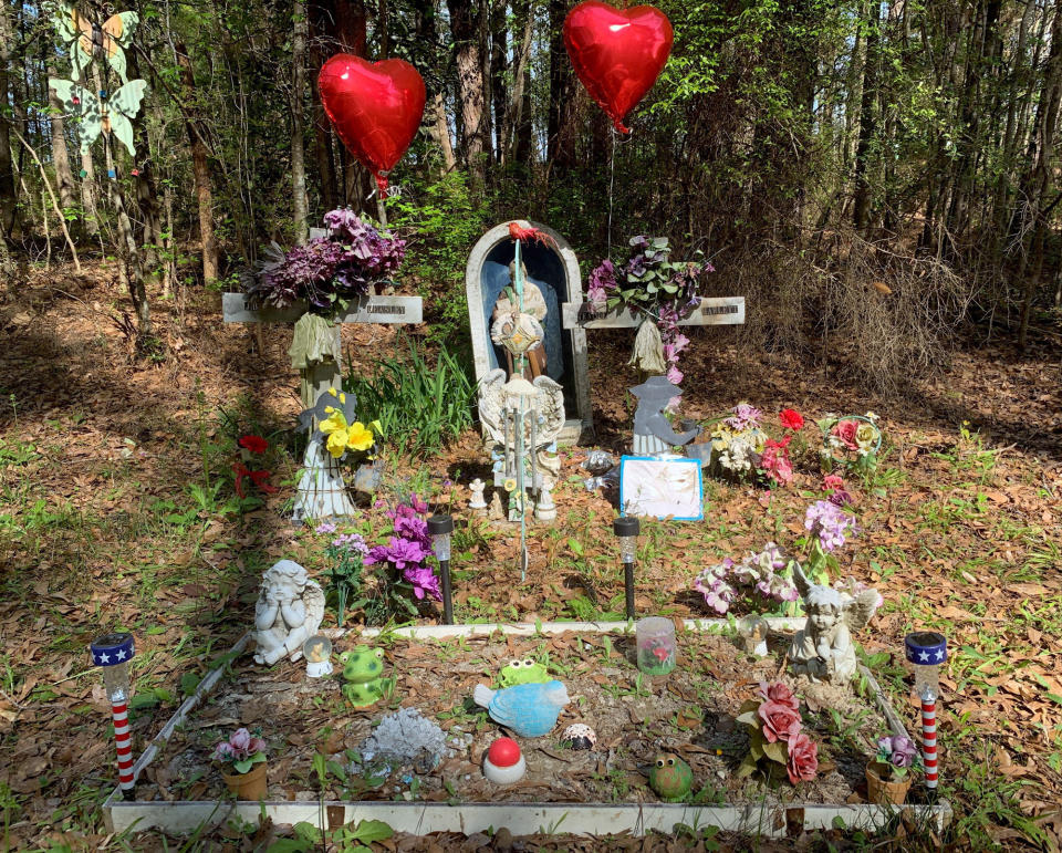 A memorial to two Alabama teenagers killed in 1999 stands beside a road at Ozark, Ala., on Tuesday, March 19, 2019. Coley McCraney, 45, of Dothan was arrested on capital murder charges in the deaths of Tracie Hawlett and J.B. Beasley, both 17. Their bodies were found in a car trunk at the spot of the memorial. Both had been shot in the head. (AP Photo/Kim Chandler)