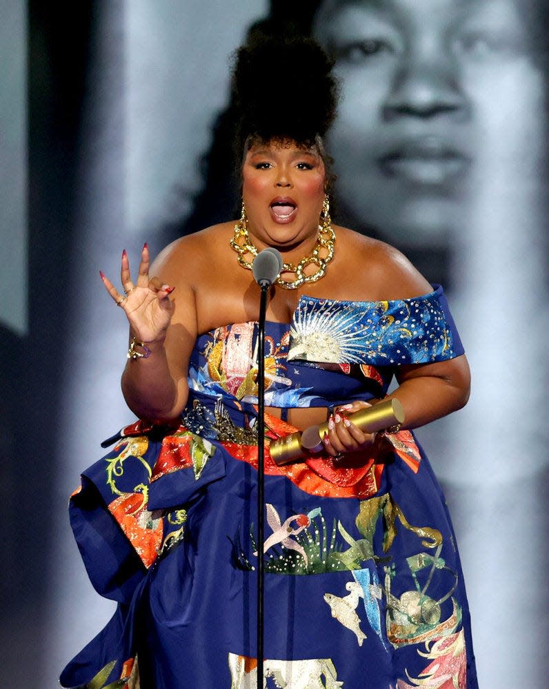 2022 PEOPLE'S CHOICE AWARDS -- Pictured: Honoree Lizzo accepts The People's Champion award on stage during the 2022 People's Choice Awards held at the Barker Hangar, on December 6, 2022 -- (Photo by: Rich Polk/E! Entertainment/NBC)