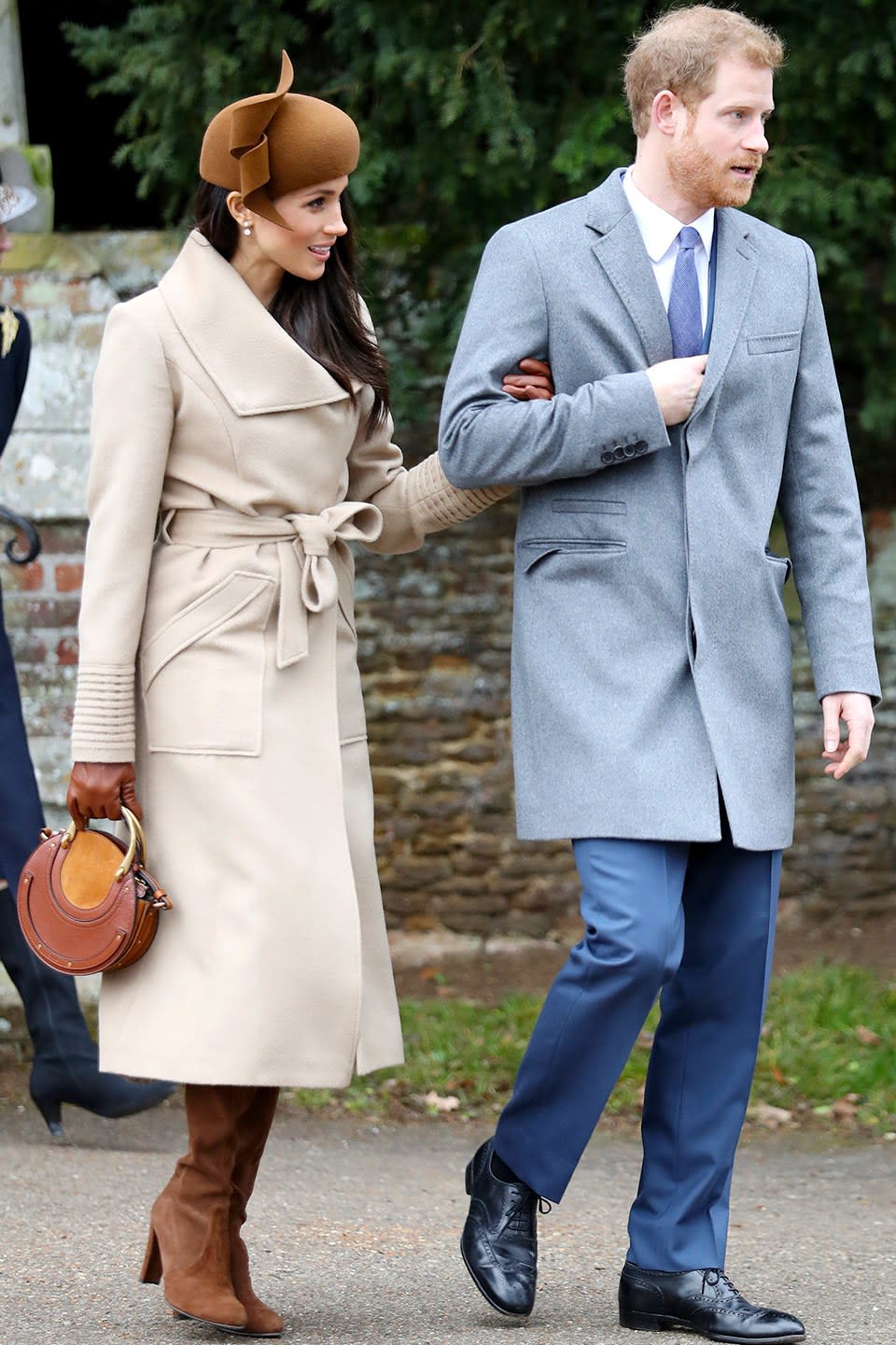 Wearing a Sentaler coat, Stuart Weitzman boots, a Philip Treacy hat, and carrying a Chloé bag.