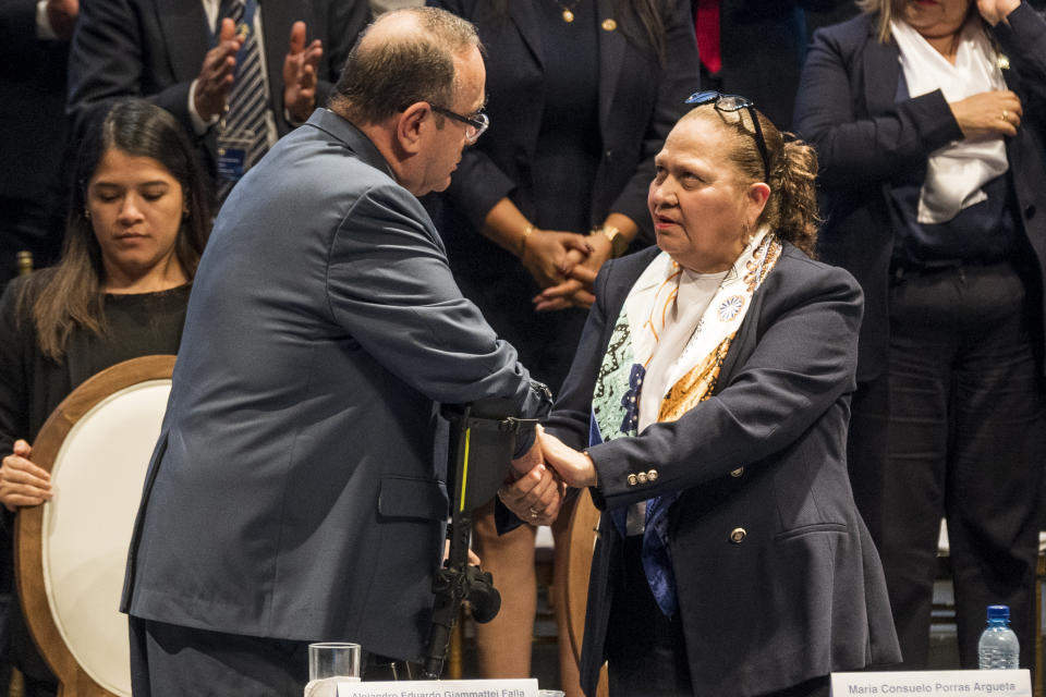 FILE - Guatemala's President Alejandro Giammattei shakes hands with Attorney General Consuelo Porras after she delivered her annual report in Guatemala City, May 17, 2023. Porras, who was originally appointed in 2018 by then President Jimmy Morales, was reappointed by Giammattei in 2022, the first time Guatemala has given its top prosecutor a second consecutive term. (AP Photo/Moises Castillo, File)