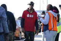 Chris Smalls, president of the Amazon Labor Union, talks to people at the bus stop across the street from an Amazon distribution center in the Staten Island borough of New York, Thursday, Oct. 21, 2021. A bid to unionize Amazon workers at the distribution center in New York City neared an important milestone, as organizers prepared to deliver hundreds of signatures to the National Labor Relations Board as soon as Monday for authorization to hold a vote. (AP Photo/Seth Wenig)