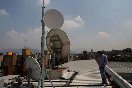 FILE PHOTO: Alejandro Cantu, founder and CEO of SkyAlert stands next to satellite antennas at the SkyAlert headquarters in Mexico City, Mexico October 9, 2017. REUTERS/Carlos Jasso/File Photo