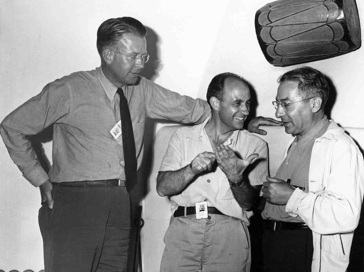 Nobel Prize winners Ernest Lawrence Enrico Fermi, and Isidor Isaac Rabi stand together talking in the late 1930s