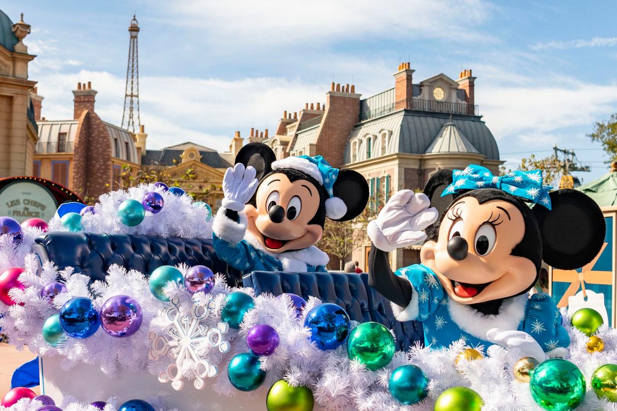 Mickey and Minnie wave to guests during 2020's Taste of EPCOT International Festival of the Holidays presented by AdventHealth.