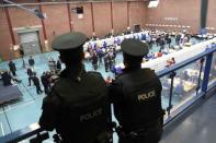 Police officers watch tellers counting ballots in the Northern Ireland assembly elections, in Ballymena, Northern Ireland March 3, 2017. REUTERS/Clodagh Kilcoyne