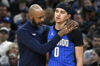 Orlando Magic head coach Jamahl Mosley, left, talks to guard Anthony Black (0) during the first half of an NBA basketball game against the Indiana Pacers, Sunday, March 10, 2024, in Orlando, Fla. (AP Photo/Phelan M. Ebenhack)