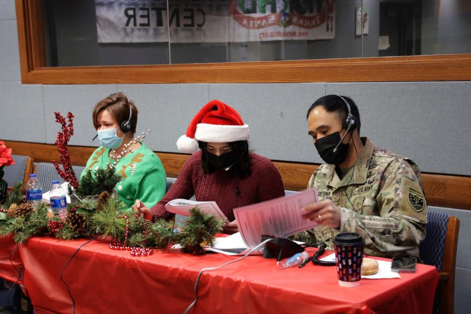 Festive volunteers answer phones and emails from children around the globe at last year’s NORAD Tracks Santa event at Peterson Air Force Base in Colorado Springs (Public Domain)