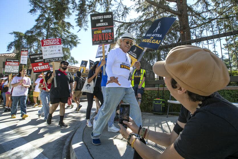 BURBANK, CA-AUGUST 18, 2023: Actor Edward James Olmos, right, joins the Writers Guild/SAG-AFTRA picket line, in front of Warners Studios in Burbank. Olmos recently announce he has beaten cancer. (Mel Melcon / Los Angeles Times)