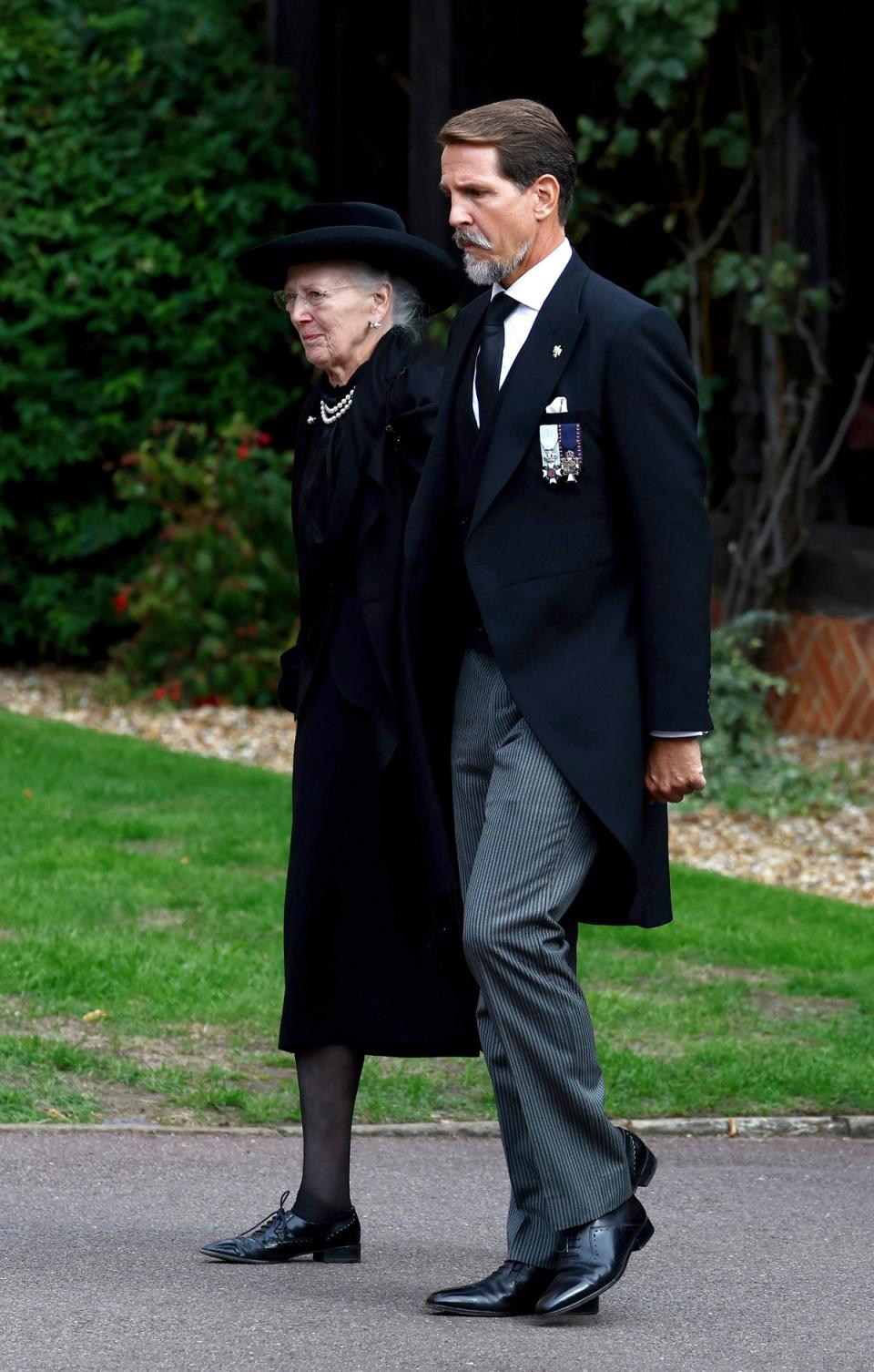 Queen Margrethe II of Denmark and Pavlos, Crown Prince of Greece arrive at St. George's Chapel, in Windsor (AP)