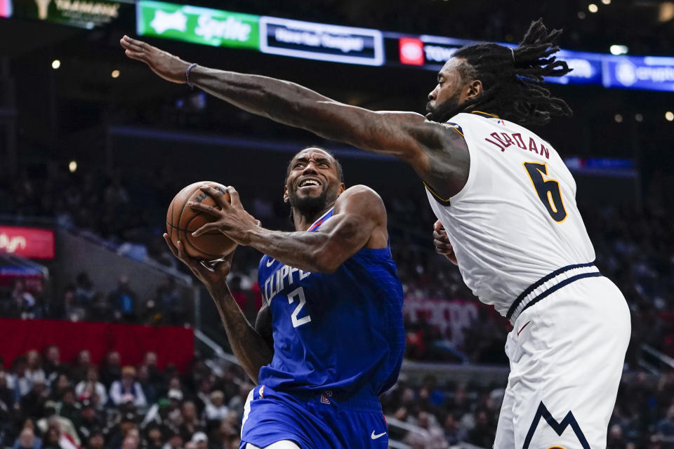 Los Angeles Clippers forward Kawhi Leonard (2) shoots as Denver Nuggets center DeAndre Jordan (6) defends during the second half of an NBA basketball game, Monday, Nov. 27, 2023, in Los Angeles. (AP Photo/Ryan Sun)