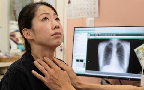 Noriko Tanaka has her thyroid checked by Misao Fujita at Fujita's clinic in Iwaki City, Fukushima - Credit: Simon Townsley