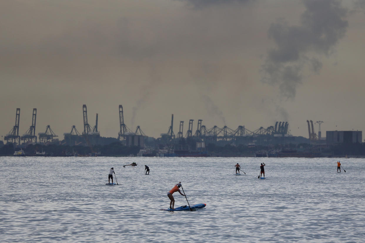 People on stand-up paddleboards at East Coast Park in Singapore.