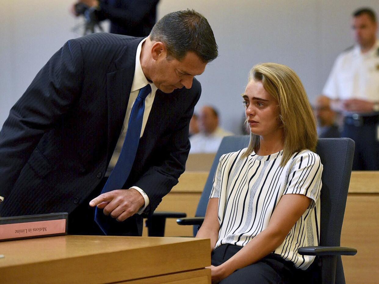 Defence lawyer Joseph Cataldo talks to his client, Michelle Carter, during the trial: Faith Ninivaggi/The Boston Herald/AP