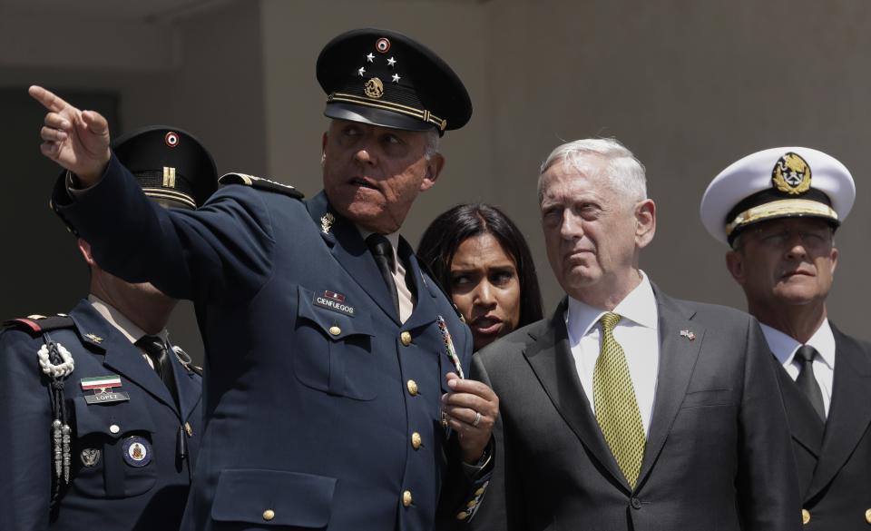 FILE - In this Friday, Sept. 15, 2017, file photo, Mexico's Defense Secretary Gen. Salvador Cienfuegos Zepeda gestures as U.S. Defense Secretary Jim Mattis listens during a reception ceremony in Mexico City. Mexico's top diplomat says the country's former defense secretary, Gen. Salvador Cienfuegos, has been arrested in Los Angeles. Foreign Relations Secretary Marcelo Ebrard wrote Thursday, Oct. 15, 2020 in his Twitter account that U.S. Ambassador Christopher Landau had informed him of Cienfuegos' arrest. (AP Photo/Rebecca Blackwell, File)