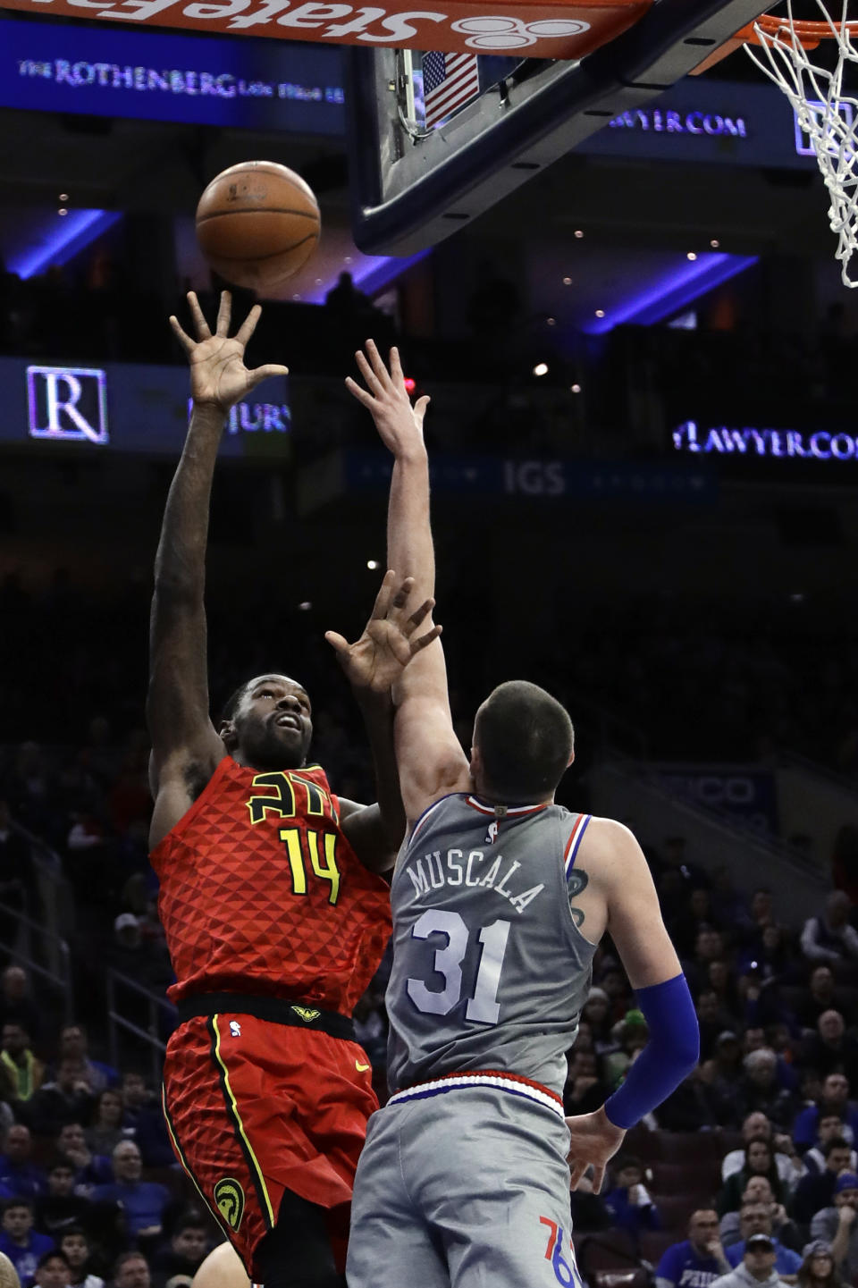 Atlanta Hawks' Dewayne Dedmon (14) shoots over Philadelphia 76ers' Mike Muscala (31) during the first half of an NBA basketball game Friday, Jan. 11, 2019, in Philadelphia. (AP Photo/Matt Slocum)