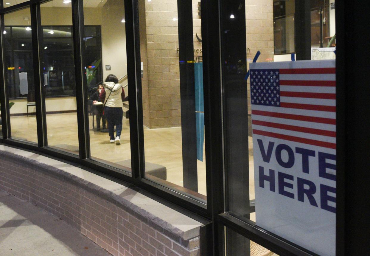 A voter approaches the registration table at First Presbyterian Church toward evening on Tuesday, Nov. 3, 2020, in St. Cloud.