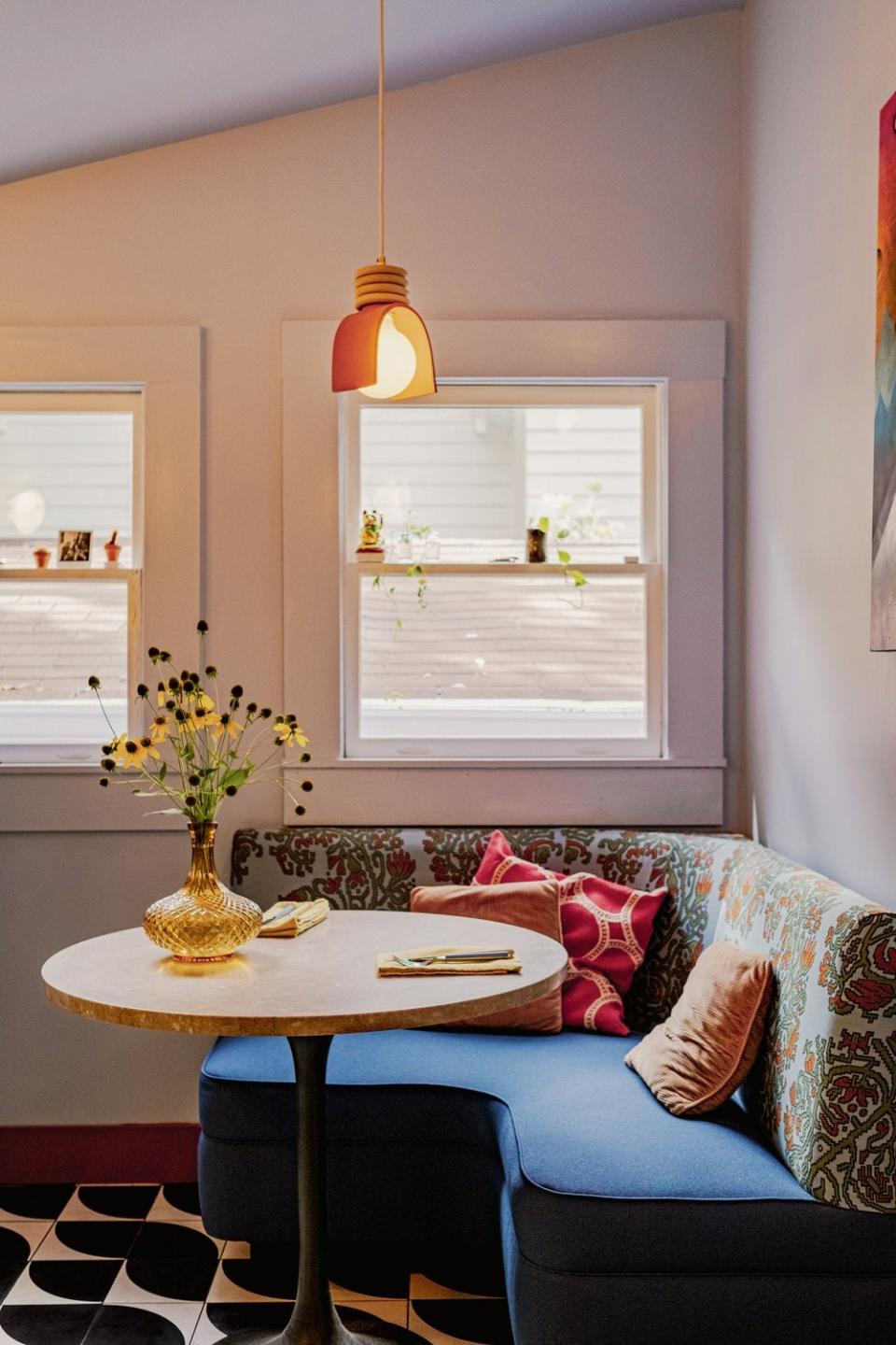 This custom breakfast banquette off the kitchen allows for indoor seating and uses soft curves to minimize any hard lines.