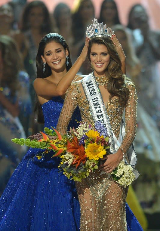 Miss Universe contestant Iris Mittenaere, right, of France is crowned the 2017 winner by former Miss Universe Pia Wurtzbach of the Philippines during the Miss Universe pageant at the Mall of Asia Arena in Manila on Jan. 30, 2017. (Photo: AFP)