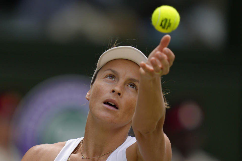 Germany's Tatjana Maria serves to Tunisia's Ons Jabeur in a women's singles semifinal match on day eleven of the Wimbledon tennis championships in London, Thursday, July 7, 2022. (AP Photo/Kirsty Wigglesworth)