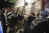 Demonstrators try to topple a steel fence during a Black Lives Matter protest at the Mark O. Hatfield United States Courthouse Saturday, July 25, 2020, in Portland, Ore. (AP Photo/Marcio Jose Sanchez)