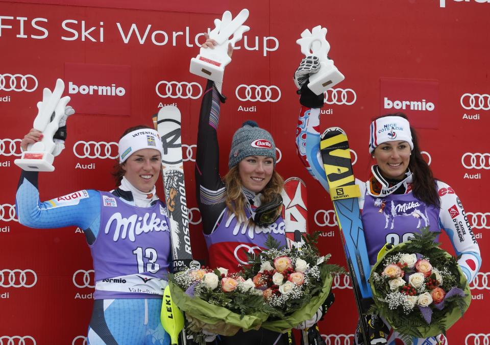 Mikaela Shiffrin, of the United States, center, the winner, second placed Maria Pietilae Holmner, left, of Sweden, and third-placed Nastasia Noens, of France, celebrate on podium after an alpine ski, women's World Cup slalom, in Bormio, Italy, Sunday, Jan. 5, 2013. (AP Photo/Marco Trovati)