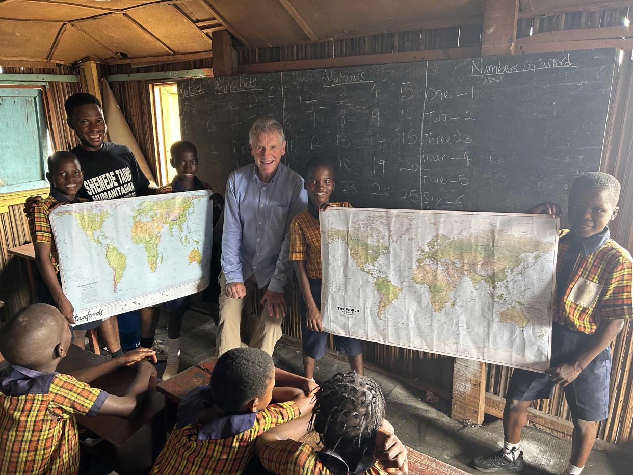 Michael Palin showing pupils how Africa looks larger in some global maps than others