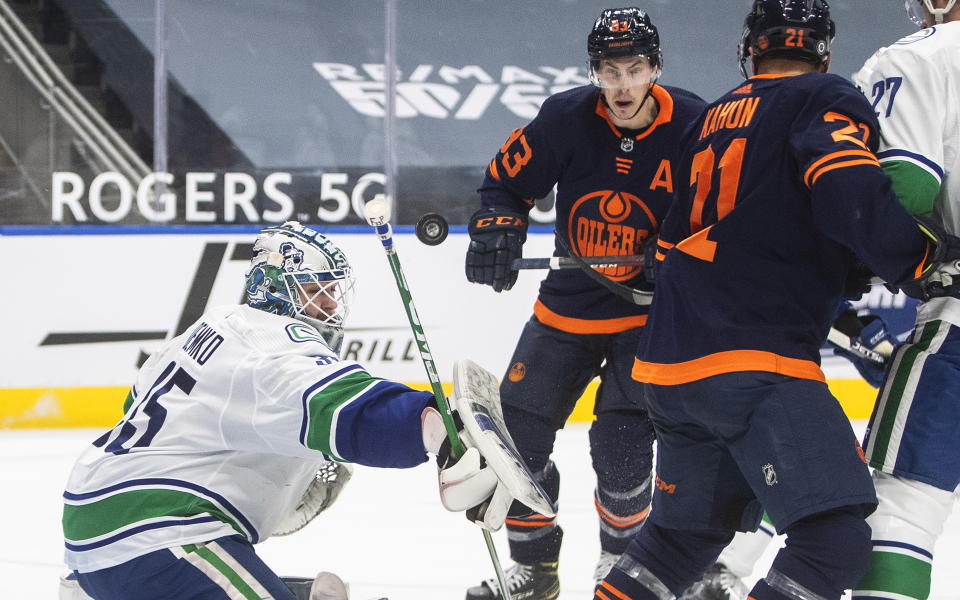 Edmonton Oilers' Ryan Nugent-Hopkins (93) is stopped by Vancouver Canucks goalie Thatcher Demko (35) during second-period NHL hockey game action in Edmonton, Alberta, Saturday, May 15, 2021. (Jason Franson/The Canadian Press via AP)