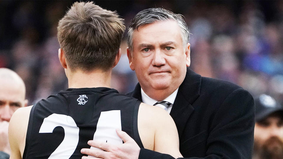 Eddie McGuire (pictured right) looks dejected after a loss and hugs a player.