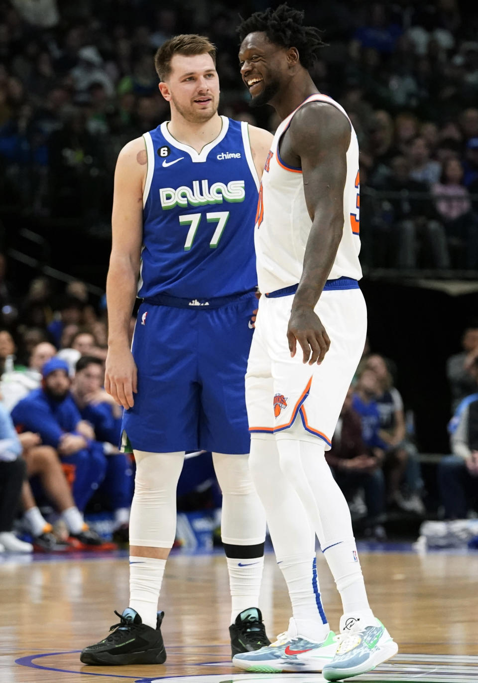 New York Knicks forward Julius Randle (30) and Dallas Mavericks guard Luka Doncic (77) laugh while standing at half-court during the first half of an NBA basketball game in Dallas, Tuesday, Dec. 27, 2022. (AP Photo/LM Otero)