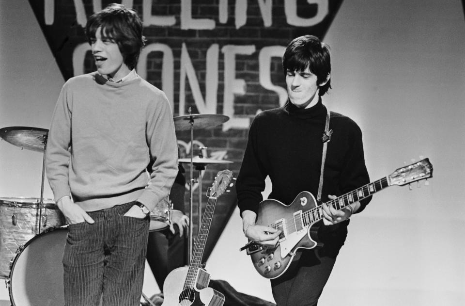 Mick Jagger and Keith Richards of the Rolling Stones prepare for a performance, circa 1965. (Photo by Terry O'Neill/Hulton Archive/Getty Images)