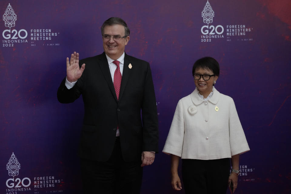 Indonesian Foreign Minister Retno Marsudi, right, greets Mexican Foreign Affairs Secretary Marcelo Ebrard upon arrival at the G20 Foreign Ministers' Meeting in Nusa Dua, Bali, Indonesia, Friday, July 8, 2022. (AP Photo/Dita Alangkara, Pool)