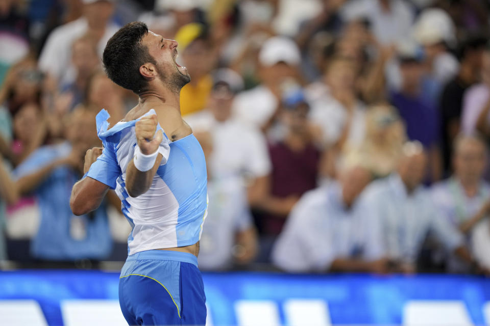 Novak Djokovic, of Serbia, rips his shirt as he celebrates his win against Carlos Alcaraz, of Spain, during the men's singles final of the Western & Southern Open tennis tournament, Sunday, Aug. 20, 2023, in Mason, Ohio. (AP Photo/Aaron Doster)