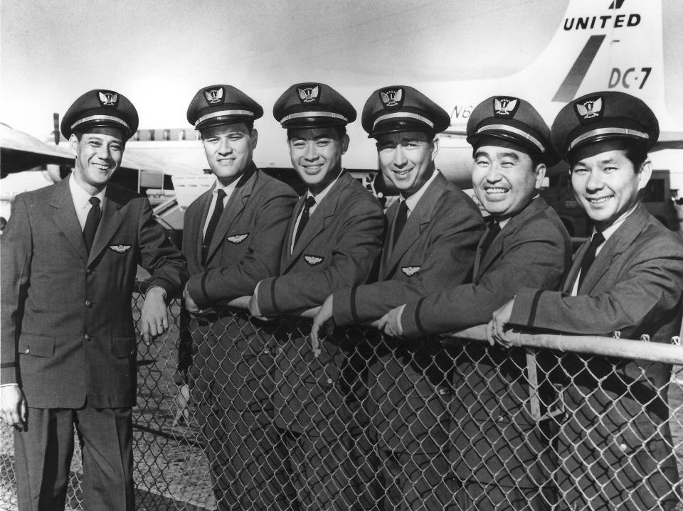 In this mid-1957 photo provided by his family, Ron Akana, third from right, poses with his United Airlines crew mates in new flight attendant uniforms. Akana, 83, worked his last route over the weekend on a United Airlines flight from Denver to Kauai, ending his career in the state where it began. Hawaii, however, wasn't his final stop. His destination is retirement in Boulder, Colo., where he has been living since 2002 to be closer to his grandchildren. He spent his first few days of retirement writing thank-you notes to well-wishers. Guinness World Records sent Akana a plaque recognizing him as the longest-serving flight attendant. He's been told he'll appear in the record book in October. Also pictured from left to right it's Matt Ah Chong, Clem Keliikipi, Timmy Pang, Eddie Takahashi and Roy Miyose. (AP Photo/Courtesy of Jean Akana-Lewis)