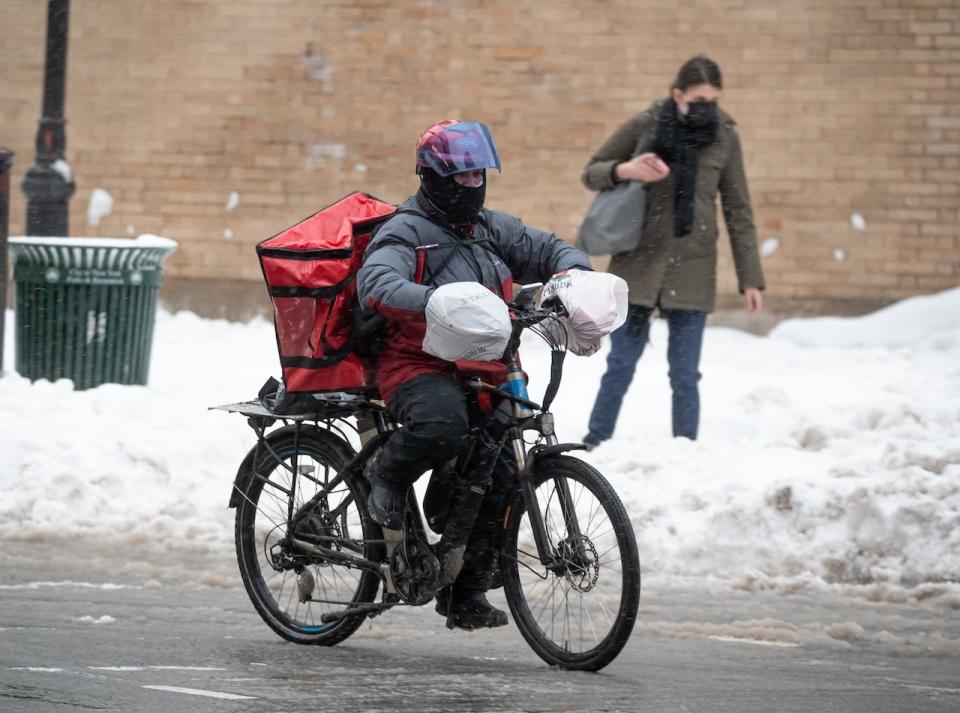A delivery person rides a bicycle on the Upper West Side during a snow storm on February 2, 2021 in New York City.