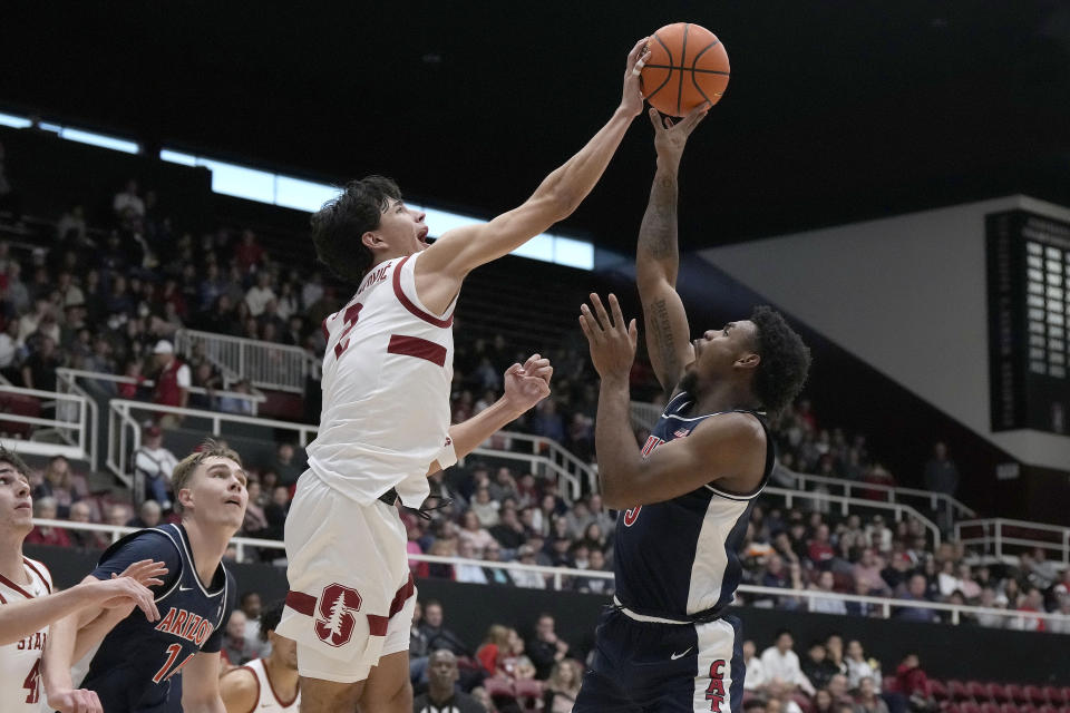 Stanford guard Andrej Stojakovic (2) blocks a shot by Arizona guard KJ Lewis (5) during the first half of an NCAA college basketball game, Sunday, Dec. 31, 2023, in Stanford, Calif. (AP Photo/Tony Avelar)