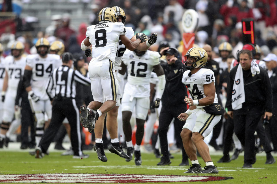 Vanderbilt cornerback Tyson Russell (8) celebrates an interception with linebackers Ethan Barr (32) and Bryan Longwell (54) during the first half of an NCAA college football game against South Carolina, Saturday, Nov. 11, 2023, in Columbia, S.C. (AP Photo/Artie Walker Jr.)