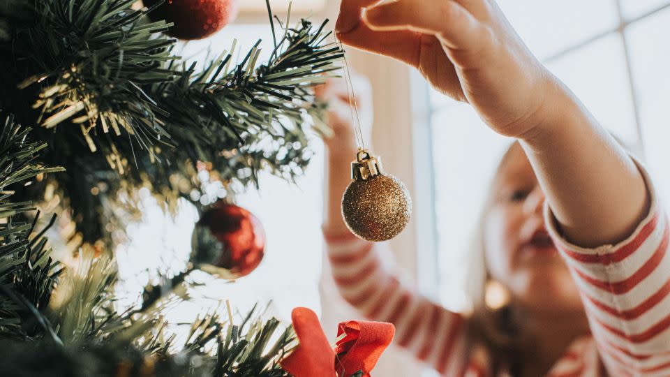 Allowing children to have one present each is another strategy for encouraging bedtime for excited kids. - Catherine Falls Commercial/Moment RF/Getty Images