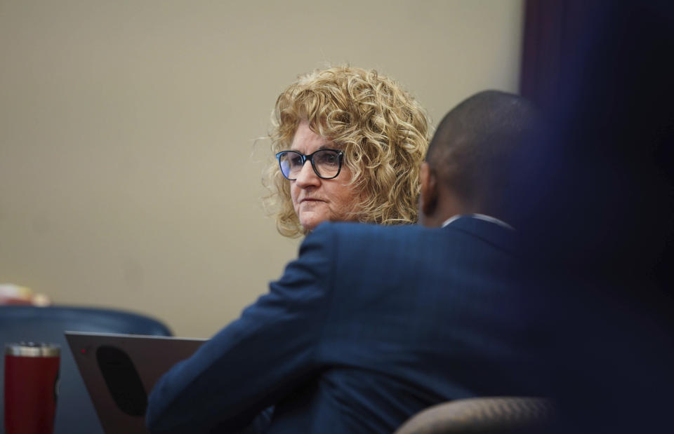 Former Michigan State University women's gymnastics coach Kathie Klages listens to prosecutor's opening statements Tuesday, Feb. 11, 2020, in Ingham County Circuit Court Judge Joyce Draganchuk's courtroom at Veterans Memorial Courthouse in Lansing, Mich.  Klages is charged with lying to investigators in connection with sexual assault complaints against sports doctor Larry Nassar.  (Anntaninna Biondo/The Grand Rapids Press via AP)