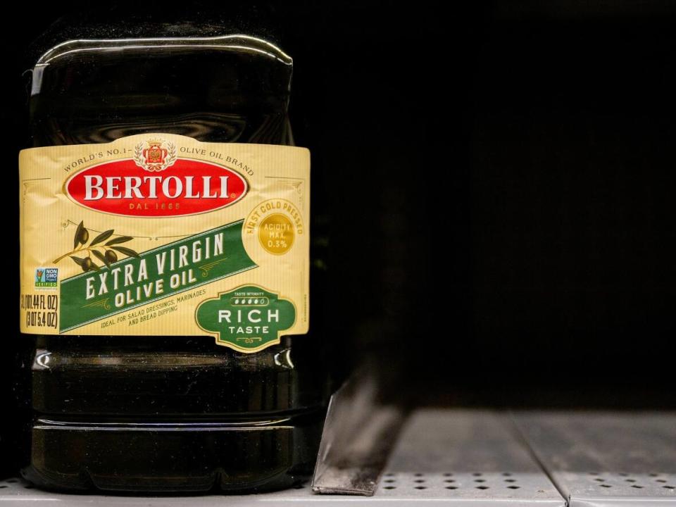 A bottle of olive oil is seen on shelves at a Walmart in Austin, Texas, on Oct. 23, 2023. Olive oil prices have soared to record levels after crops in Spain, Italy and elsewhere were hit by wildfires and drought. (Brandon Bell/Getty Images - image credit)