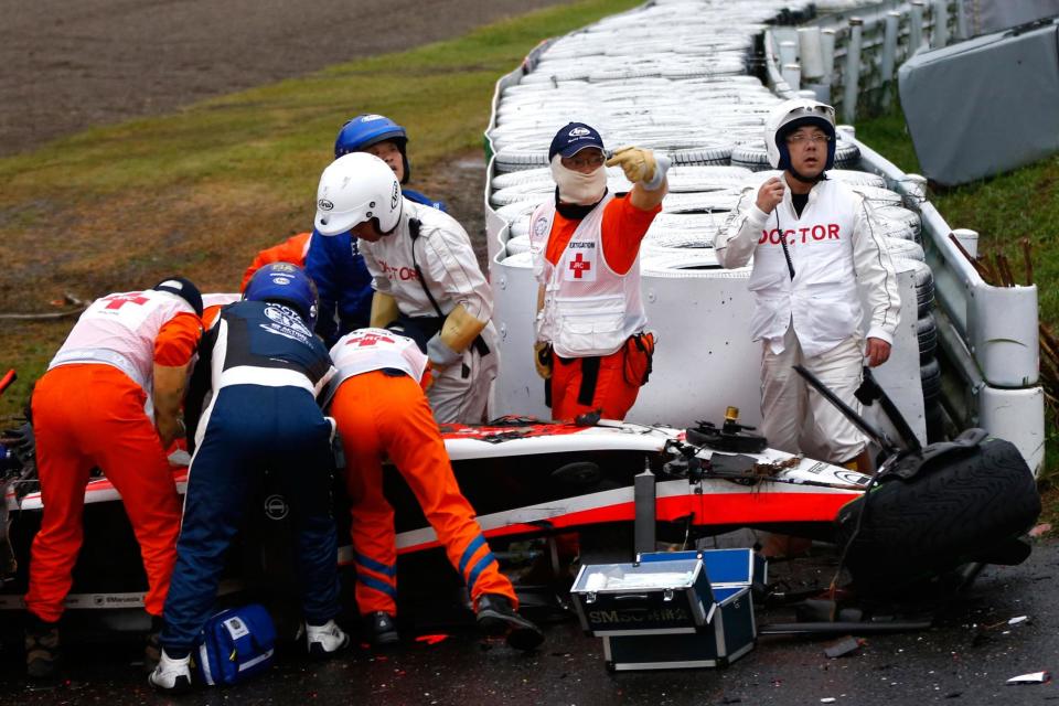 Bianchi receives medical treatment after crashing during the Japanese Formula One Grand Prix in 2014Getty