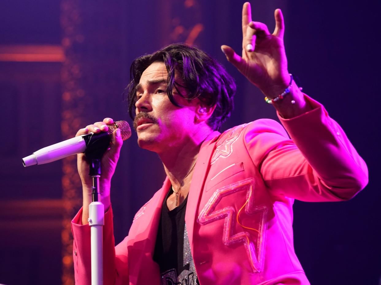 Tom Sandoval performing in a pink blazer