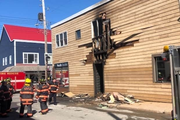 Firefighters at the scene of a fire in a building in downtown New Glasgow on April 11, 2021