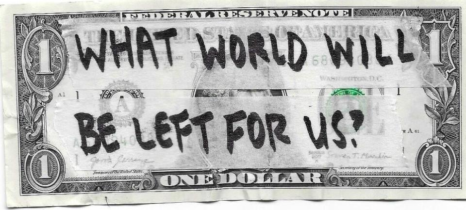 A one-dollar bill with the handwritten message, "What world will be left for us?"