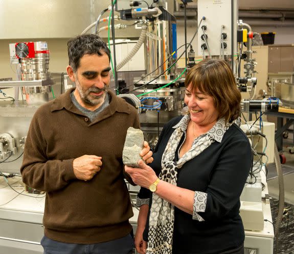 Australian scientists Allen Nutman (left) and Vickie Bennet (right), who co-authored Wednesday's study, pose with a specimen of 3.7 billion-year-old stromatolites from Isua, Greenland.