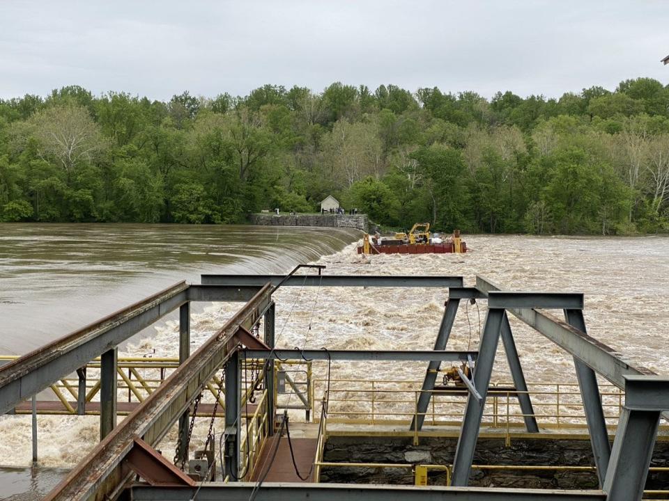 A large barge being used by a National Park Service contractor crosses Dam No. 4 along the Potomac River after breaking free from its moorings during high waters over the weekend.