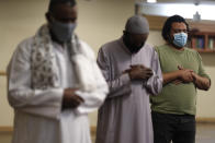 Muslims pray as they practice social distancing during an evening prayer called "tarawih" marking the first eve of the holy fasting month of Ramadan at Chicago's Muslim Community Center on Monday, April 12, 2021. (AP Photo/Shafkat Anowar)