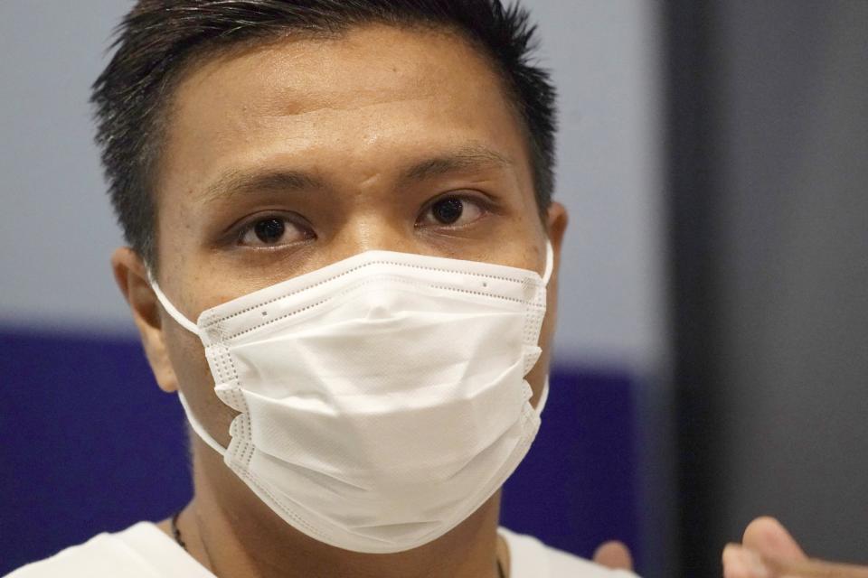 Pyae Lyan Aung, a substitute goalkeeper of the Myanmar national team who raised a three-finger salute during a qualifying match for the 2022 World Cup in late May, speaks at Kansai International Airport in Osaka Prefecture, Japan on Thursday, June 17, 2021. Pyae Lyan Aung has refused to return home and is seeking asylum, a request the government was considering taking into account unrest in his country following a coup. (Kyodo News via AP)