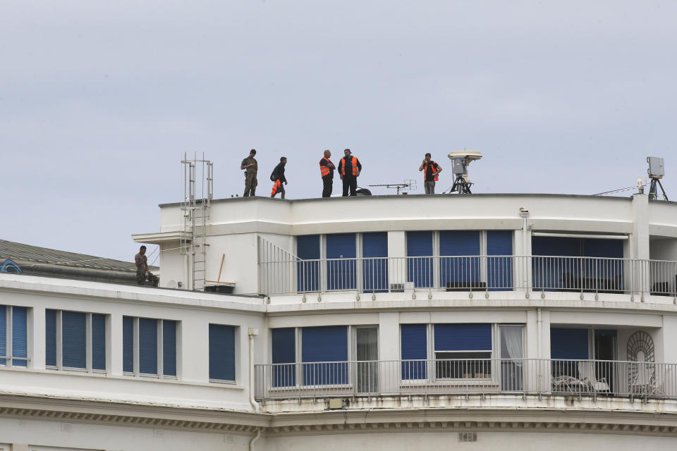 Soldiers and security forces secure the roof of the Casino Bellevue, a venue of the upcoming G7 summit, Tuesday, Aug.20, 2019 in Biarritz, southwestern France. French police are setting up checkpoints and combing Atlantic beaches to secure the southwestern coast for world leaders coming for the G-7 summit. (AP Photo/Bob Edme)