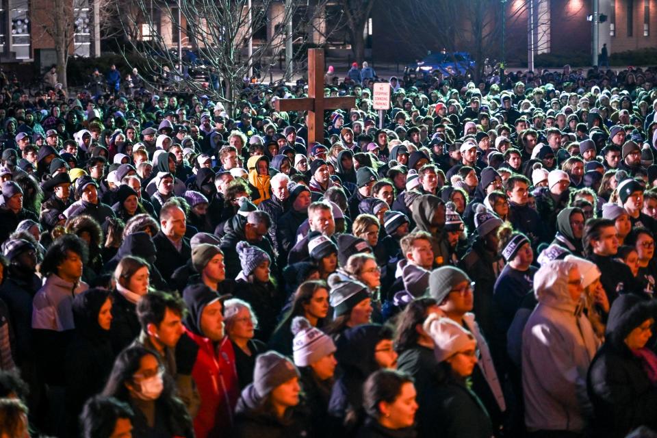 People gather around the Michigan State University Auditorium on Wednesday, Feb. 15, 2023, during a candlelight vigil honoring the victims of Monday’s mass shooting on campus.