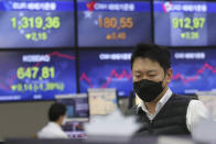 A currency trader watches monitors at the foreign exchange dealing room of the KEB Hana Bank headquarters in Seoul, South Korea, Wednesday, Feb. 26, 2020. Asian shares slid Wednesday following another sharp fall on Wall Street as fears spread that the growing virus outbreak will put the brakes on the global economy.(AP Photo/Ahn Young-joon)